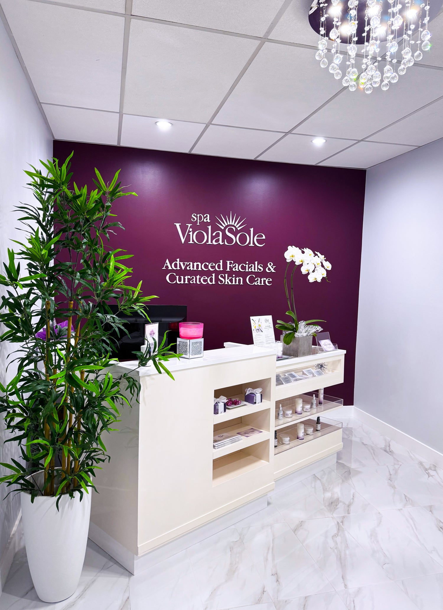 Spa ViolaSole reception area with purple wall and white decor